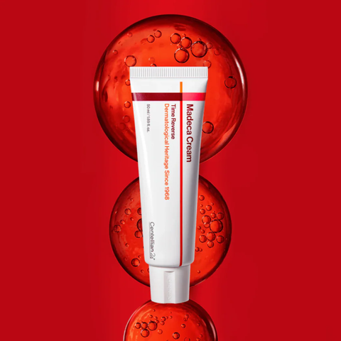 Centellian 24 Madeca Cream on red background with Centella serum bubbles